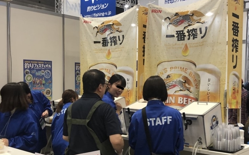 キリン一番搾りをふるまう女性とビール。多摩ケータリング俱楽部。